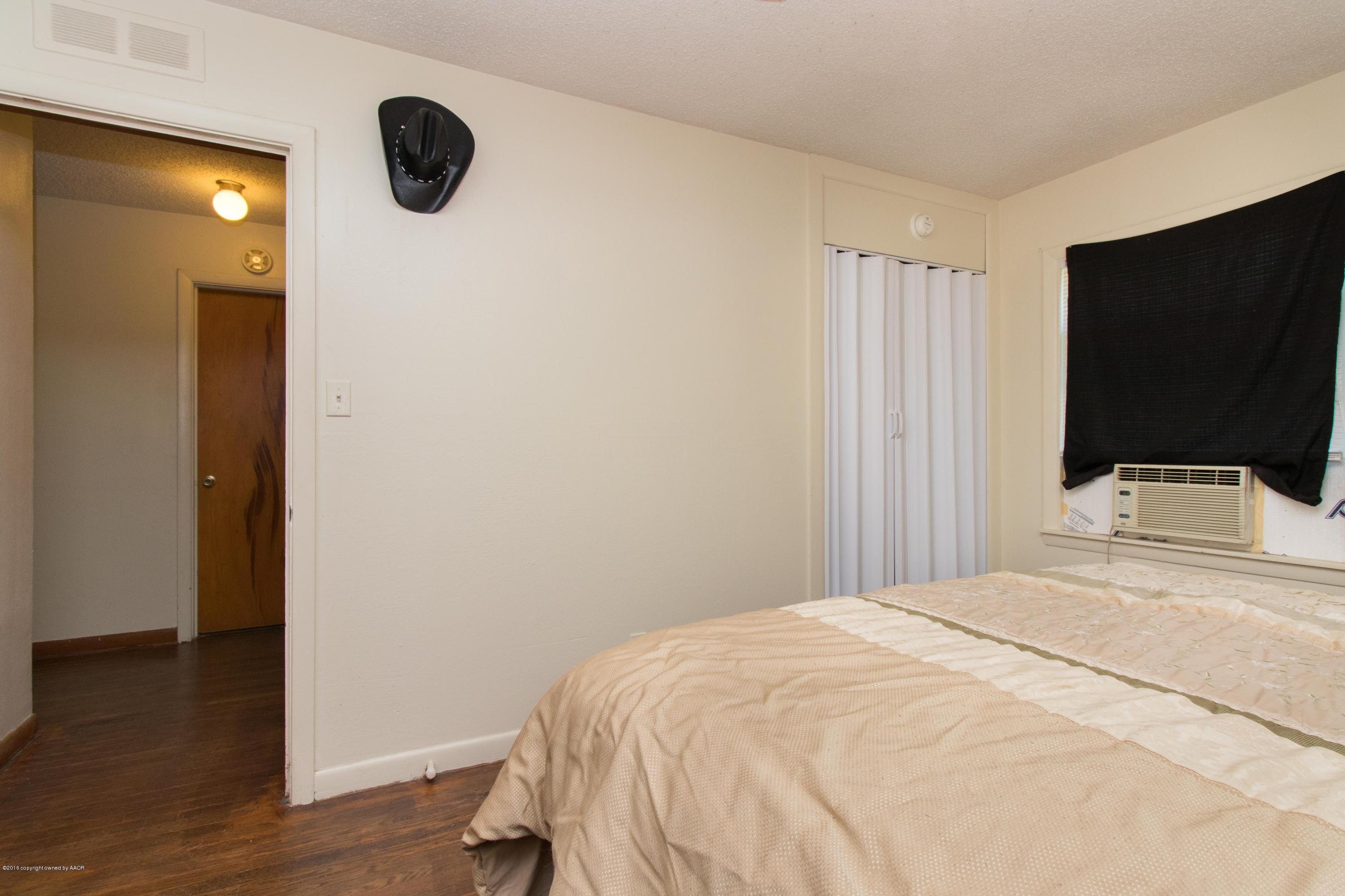 4309 South Monroe Street Amarillo, TX 79110 - Photo 16 of 16 a bedroom with a bed and a flat tv screen on dresser