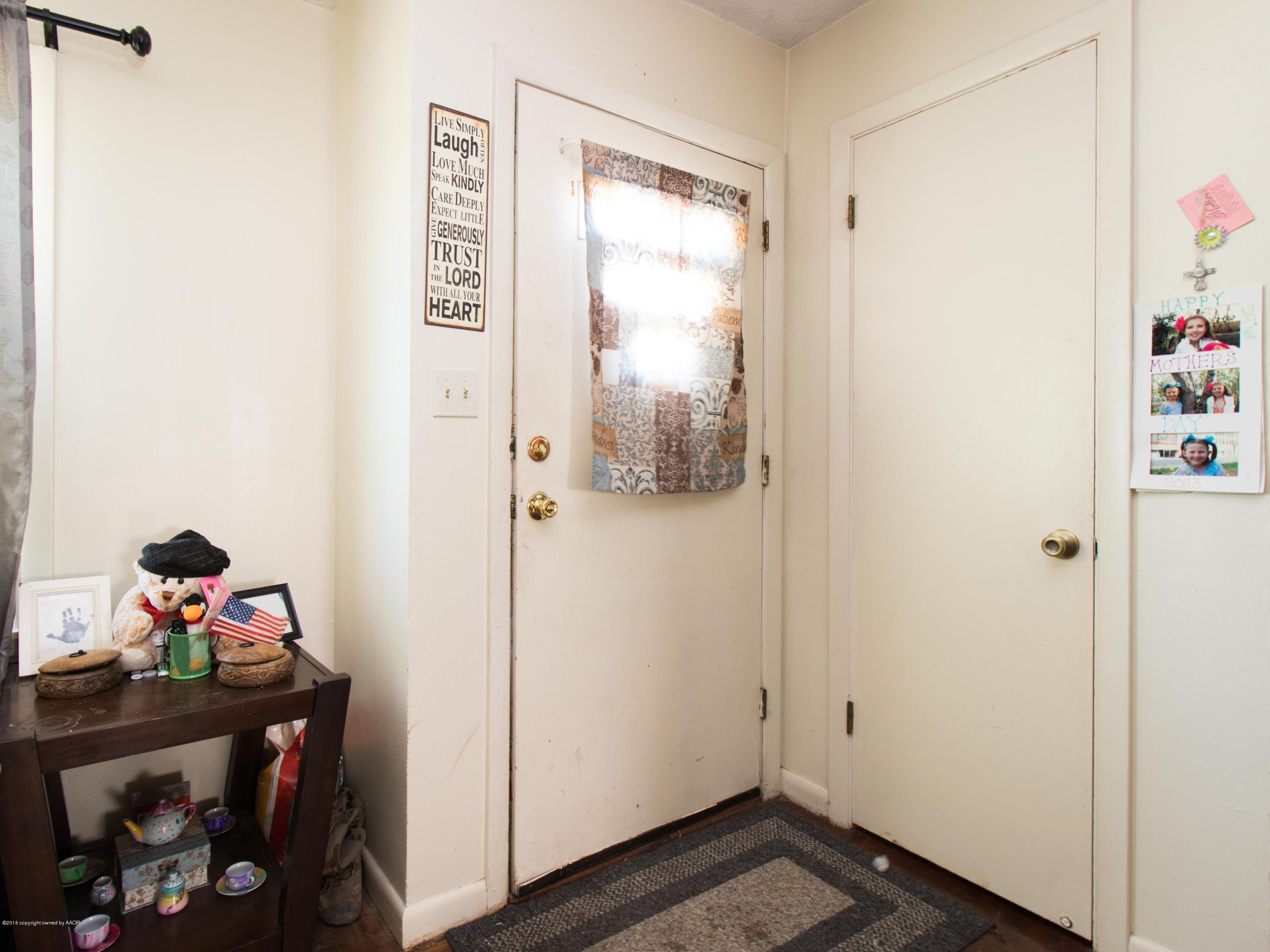 4309 South Monroe Street Amarillo, TX 79110 - Photo 7 of 16 a view of a hallway to room with wooden floor and closet