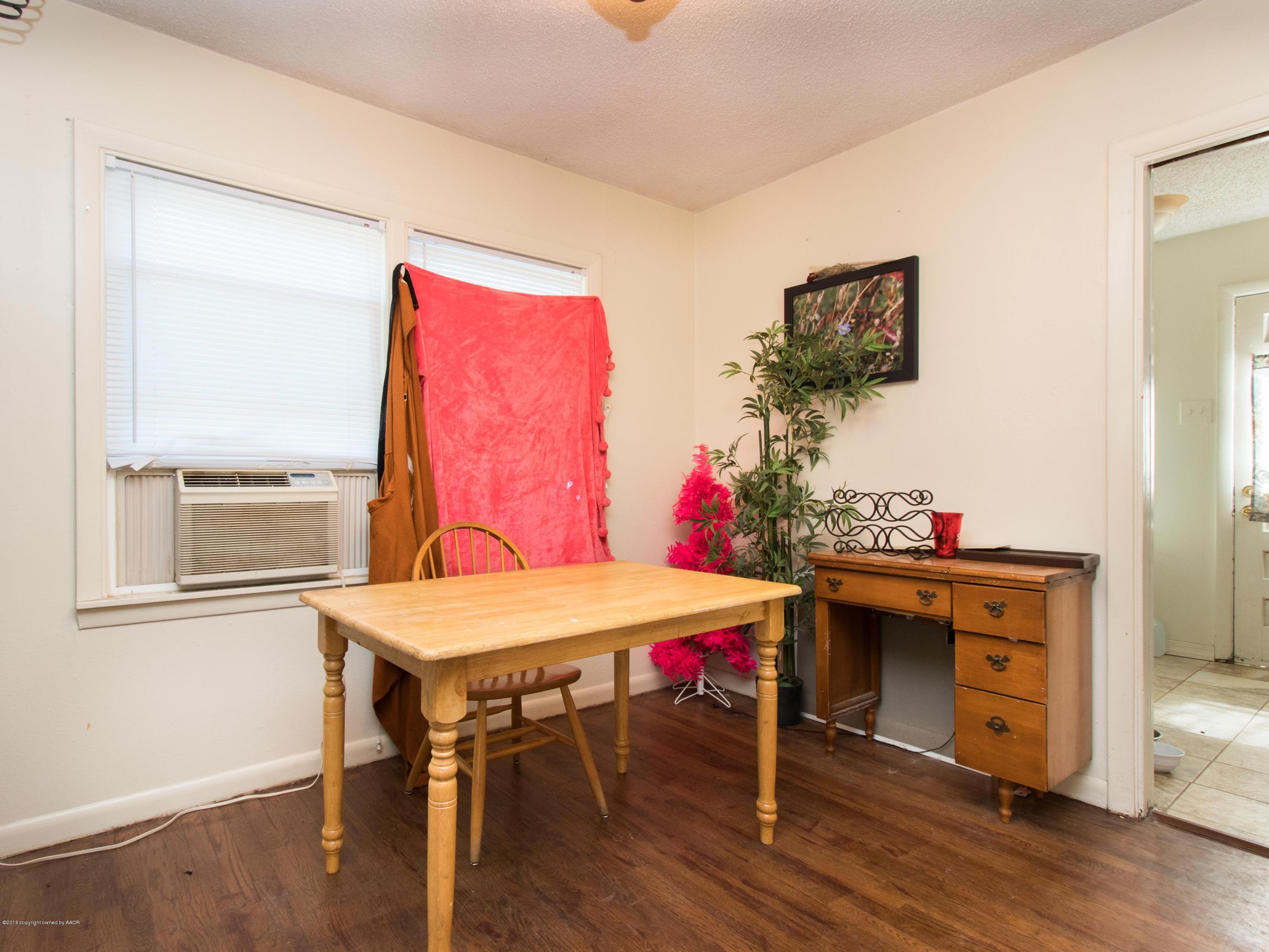 4309 South Monroe Street Amarillo, TX 79110 - Photo 8 of 16 a view of a dining room with furniture and wooden floor