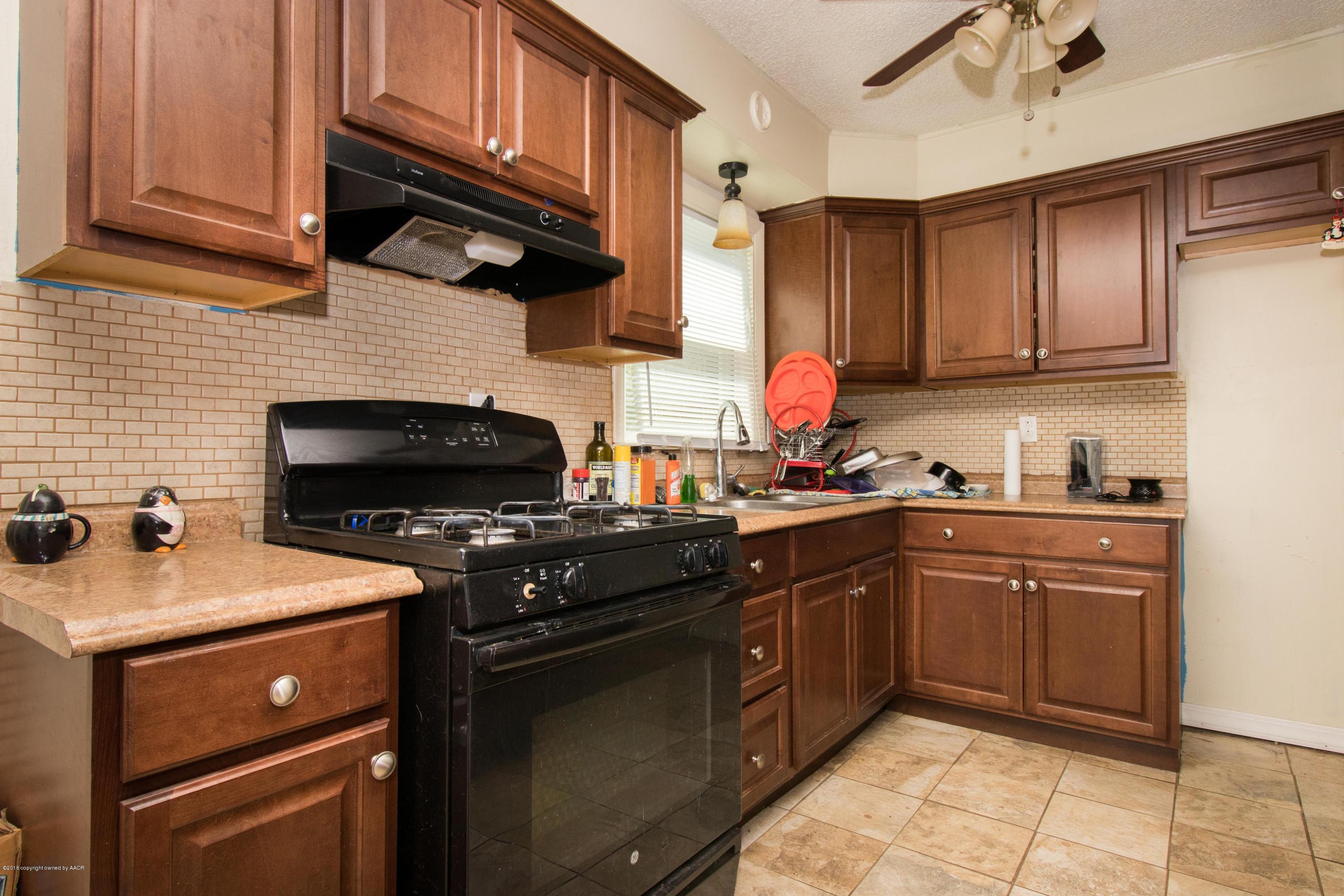 4309 South Monroe Street Amarillo, TX 79110 - Photo 9 of 16 a kitchen with a sink stove and microwave