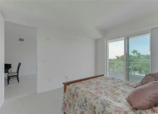 a bedroom with a bed and a chair