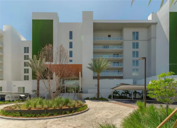 a view of a house with a small yard and sitting area