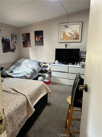 a bedroom with bed and a tv