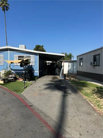 a view of a house with backyard porch and sitting area