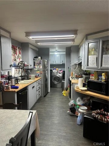 a kitchen with a sink a stove and chairs