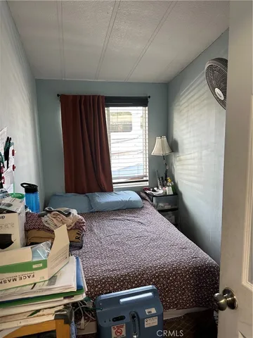 a bedroom with a bed and dresser