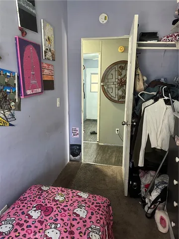 a bedroom with a bed and a lamp