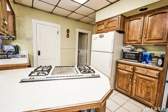 a white refrigerator freezer sitting inside of a kitchen