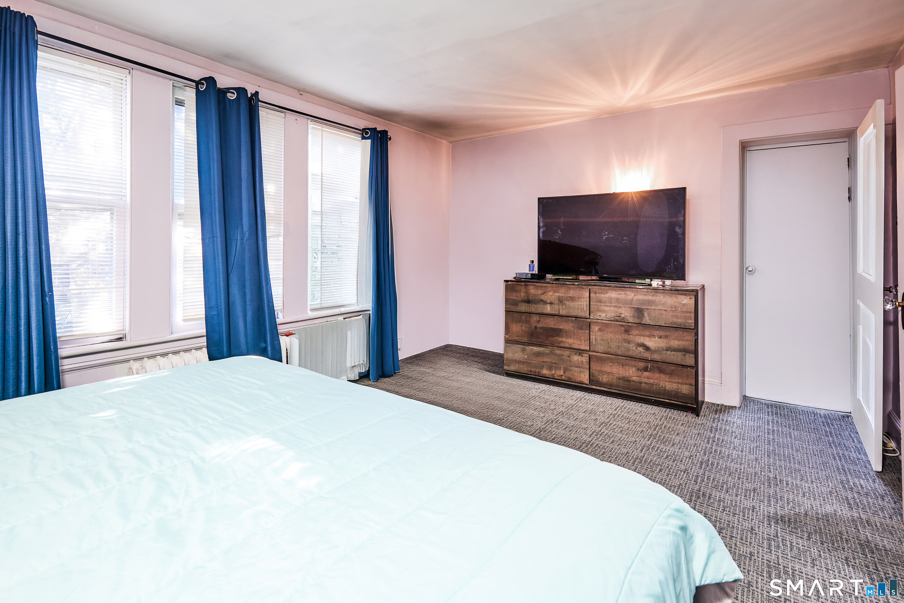 74 Harlem Avenue Bridgeport, CT 06606 - Photo 20 of 40 a bedroom with a bed and flat screen tv