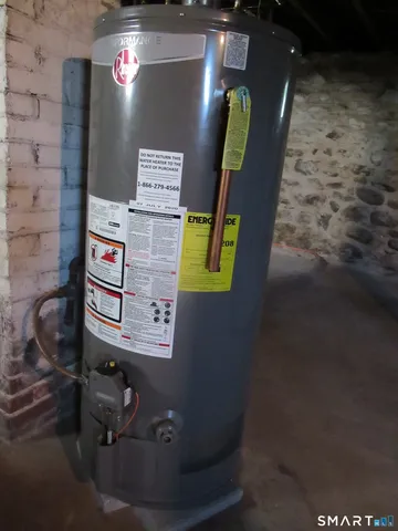 a white toilet sitting next to a white wall