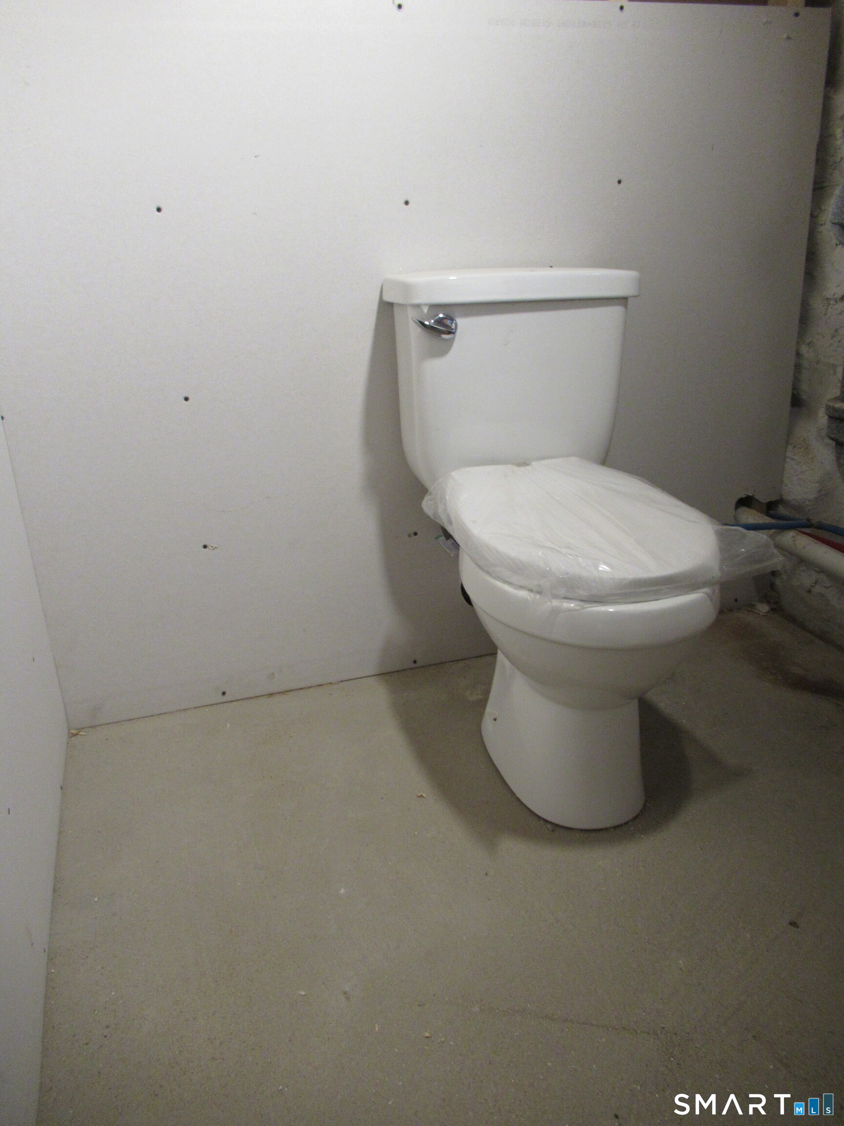 74 Harlem Avenue Bridgeport, CT 06606 - Photo 29 of 40 a white toilet sitting next to a white wall