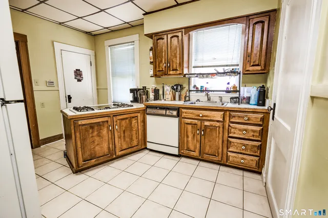 a kitchen with stainless steel appliances granite countertop a stove sink and cabinets