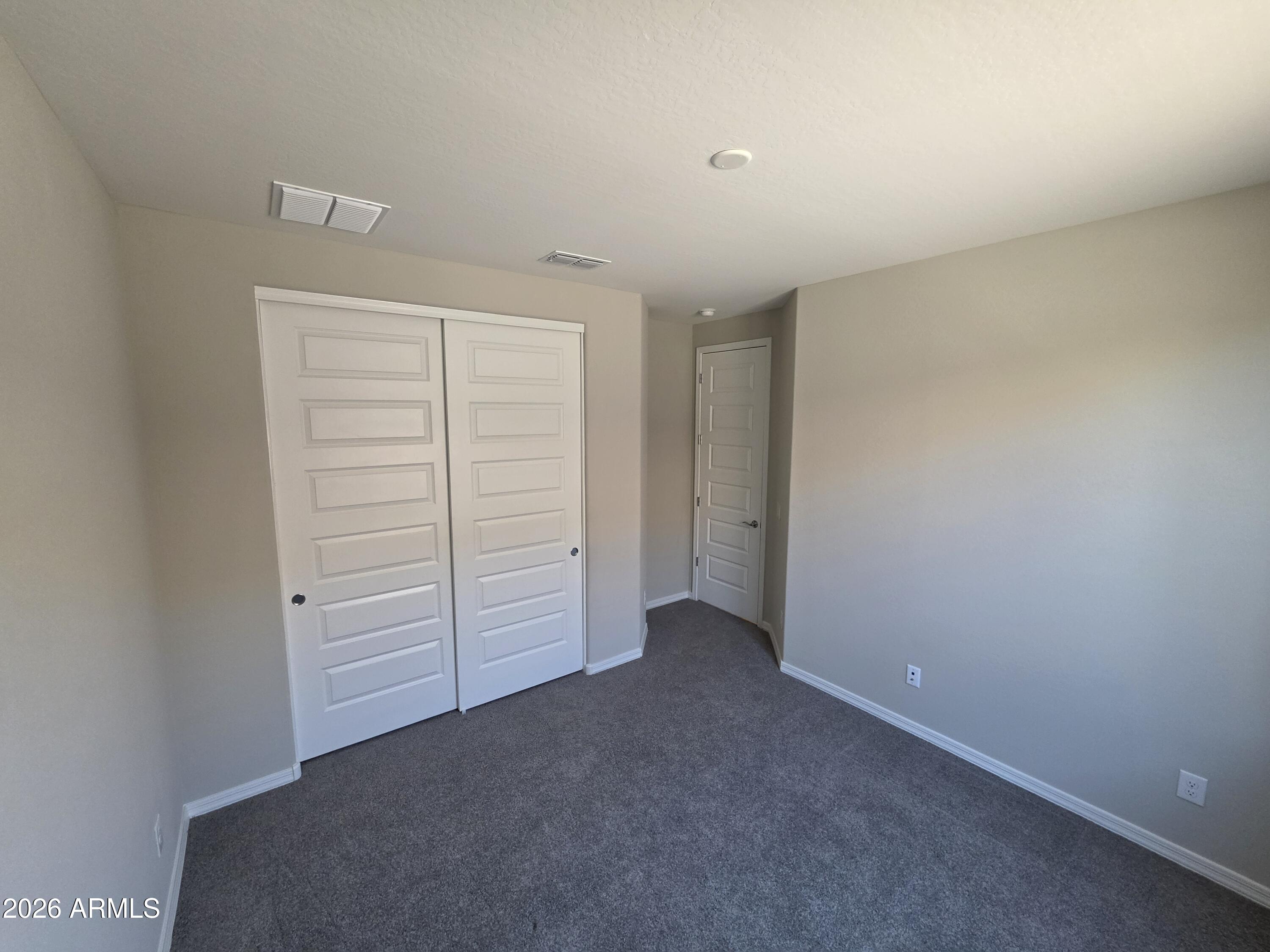 7128 West Coles Road Laveen, AZ 85339 - Photo 31 of 38 an empty room with closet