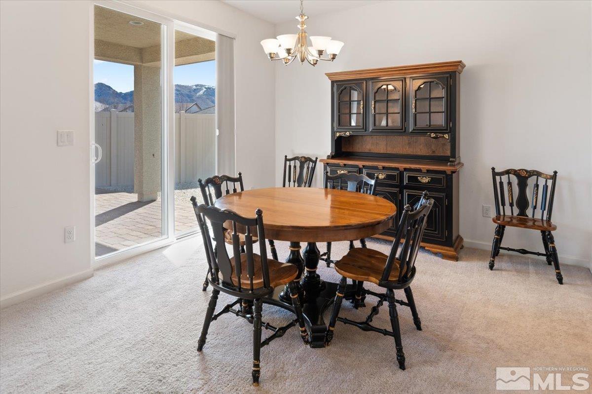 9700 Declan Drive Reno, NV 89521 - Photo 13 of 34 a view of a dining room with furniture and a chandelier