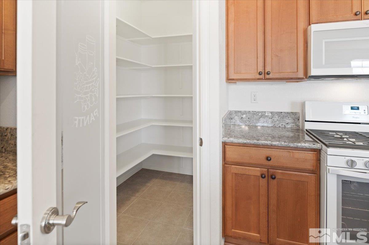 9700 Declan Drive Reno, NV 89521 - Photo 16 of 34 a kitchen with a white cabinets and a stove