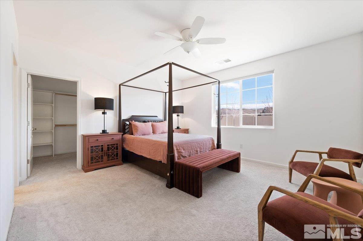 9700 Declan Drive Reno, NV 89521 - Photo 17 of 34 a bedroom with a bed and a chandelier