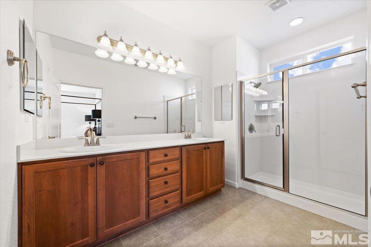 9700 Declan Drive Reno, NV 89521 - Photo 19 of 34 a spacious bathroom with a double vanity sink mirror and double
