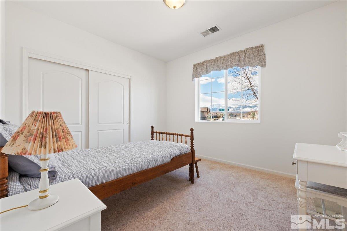 9700 Declan Drive Reno, NV 89521 - Photo 22 of 34 a bedroom with a bed and a dresser