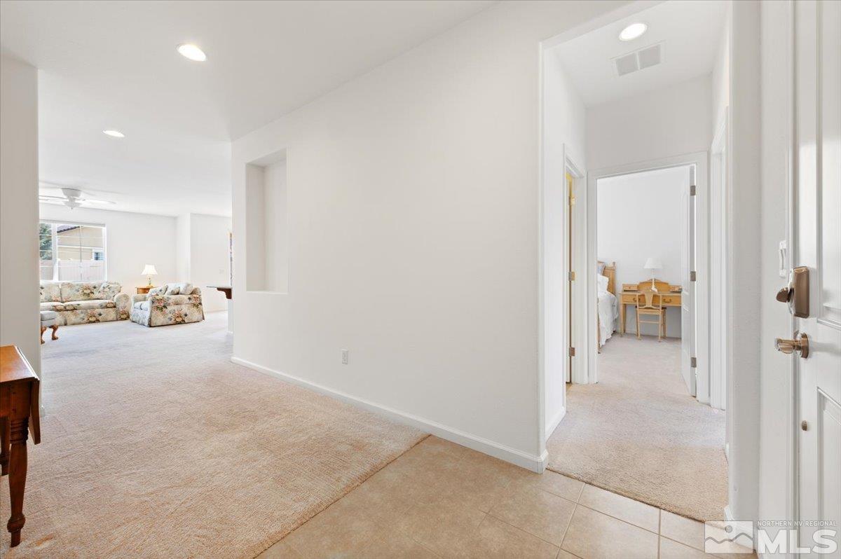 9700 Declan Drive Reno, NV 89521 - Photo 6 of 34 a view of a hallway to a livingroom and a bathroom