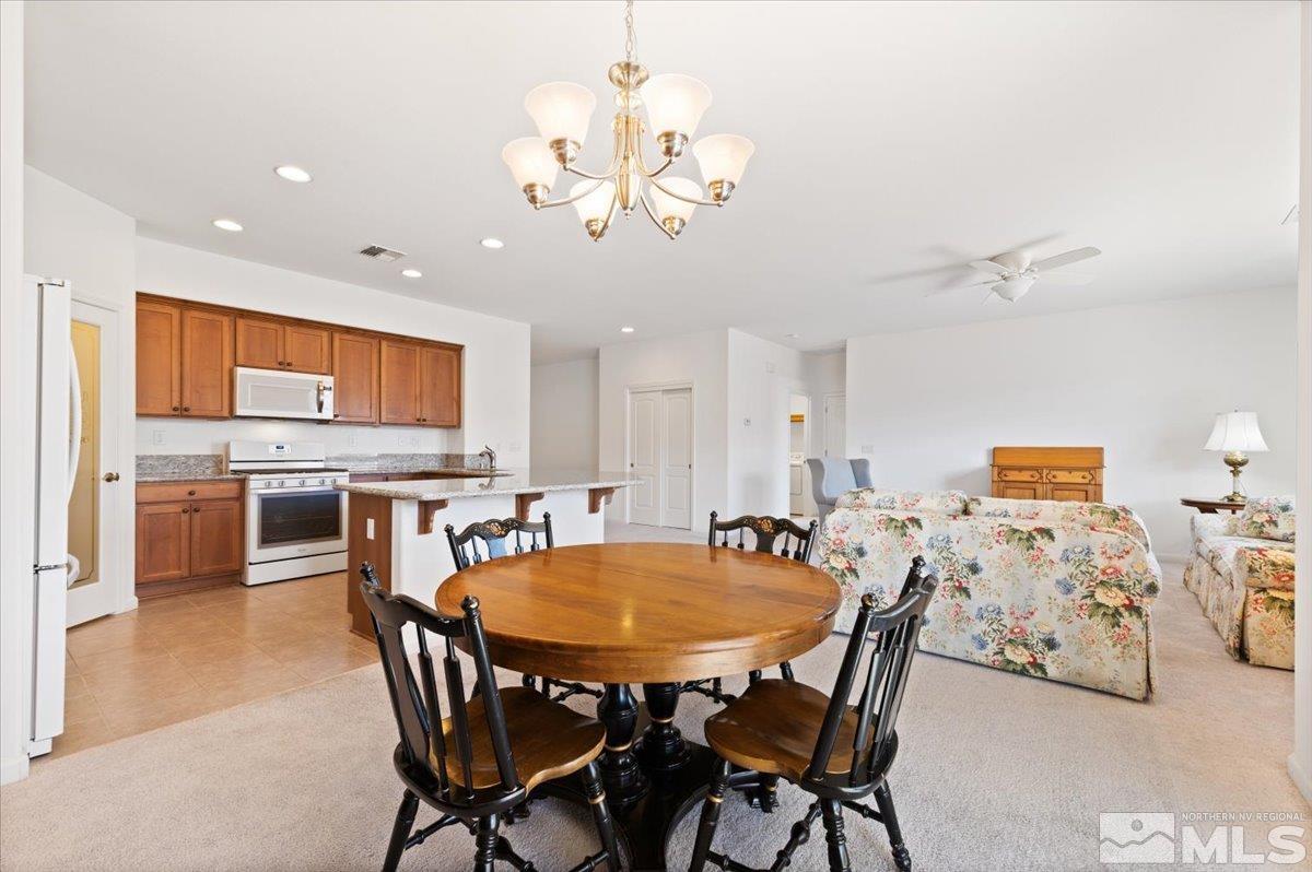 9700 Declan Drive Reno, NV 89521 - Photo 10 of 34 a view of a dining room with furniture and wooden floor