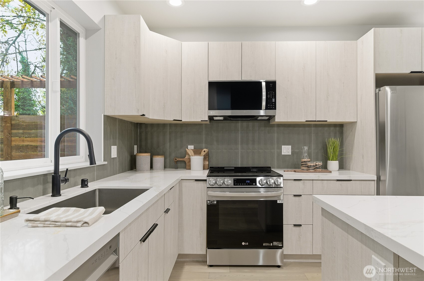11831 59th Avenue South, Unit C Seattle, WA 98178 - Photo 5 of 26 a kitchen with stainless steel appliances granite countertop a sink a stove a microwave and cabinets