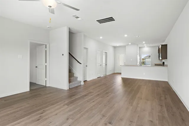a view of a kitchen with wooden floor and a window