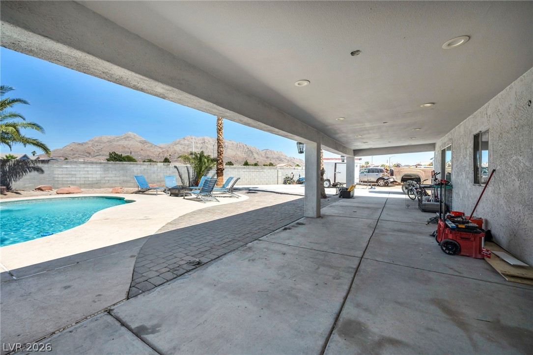 5882 Rio Tinto Way Las Vegas, NV 89110 - Photo 48 of 56 A spacious covered patio overlooks a sparkling pool with a dramatic mountain backdrop.