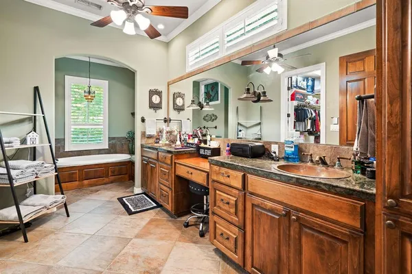 a spacious en suite bathroom with double vanity and a mirror