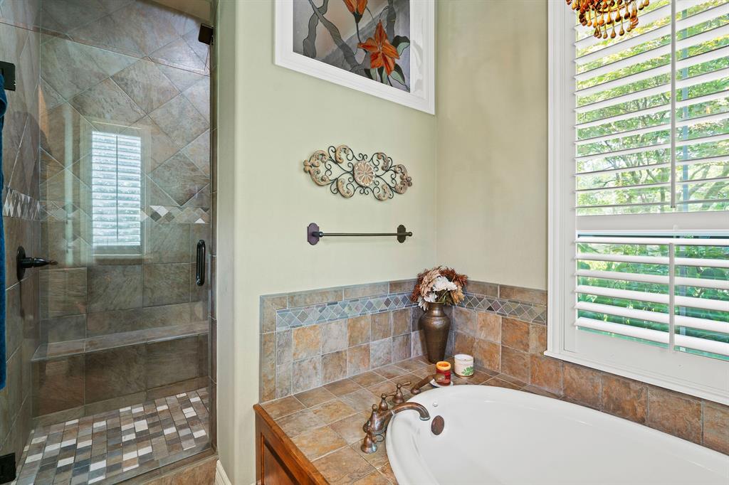 165 Whistler Lane Hallsville, TX 75650 - Photo 14 of 40 a bathroom with a sink a mirror and a shower