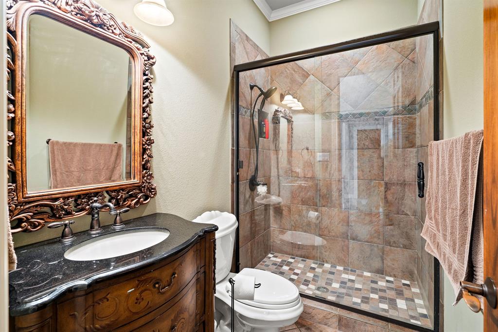 165 Whistler Lane Hallsville, TX 75650 - Photo 18 of 40 a bathroom with a double vanity sink toilet mirror and shower