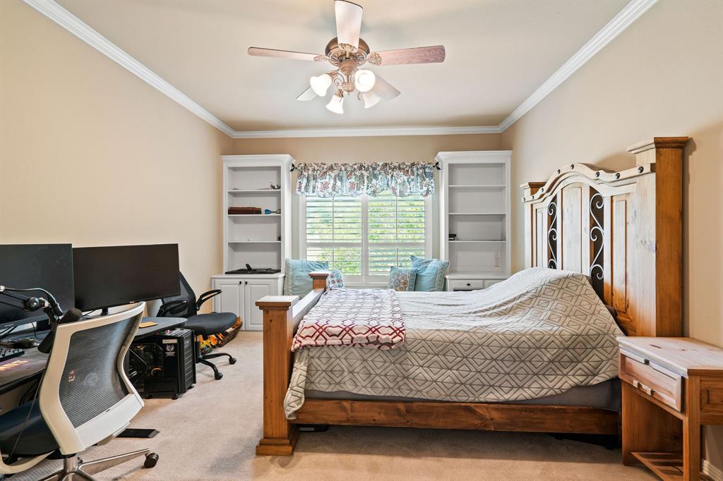 165 Whistler Lane Hallsville, TX 75650 - Photo 22 of 40 a bedroom with a bed a flat screen tv and a window