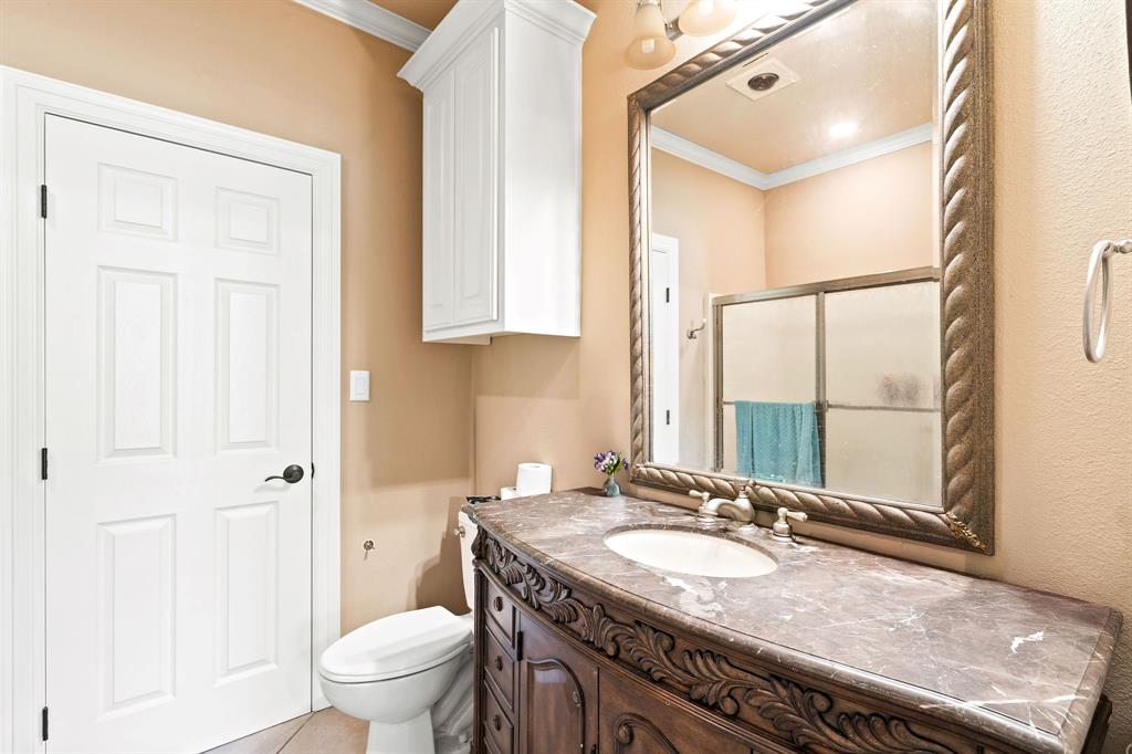 165 Whistler Lane Hallsville, TX 75650 - Photo 23 of 40 a bathroom with a granite countertop sink a toilet and a mirror