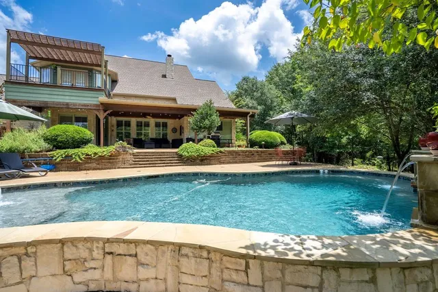 an aerial view of a house with swimming pool lake view and mountain view