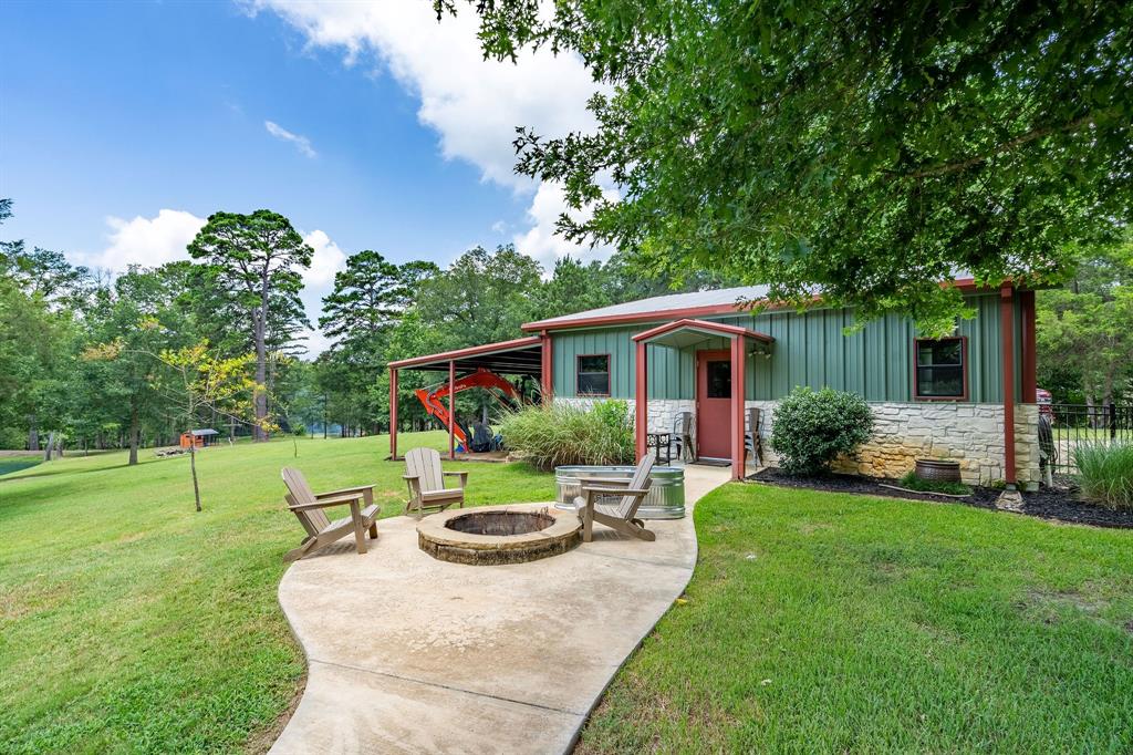 165 Whistler Lane Hallsville, TX 75650 - Photo 33 of 40 a view of a house with backyard sitting area and garden
