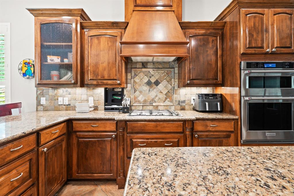 165 Whistler Lane Hallsville, TX 75650 - Photo 6 of 40 a kitchen with stainless steel appliances granite countertop a stove and cabinets