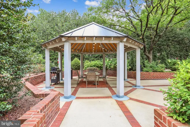 a view of a patio with table and chairs under an umbrella