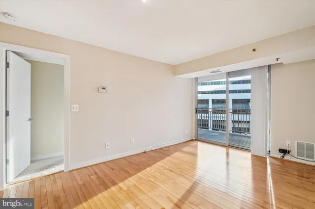 a view of wooden floor and windows in a room