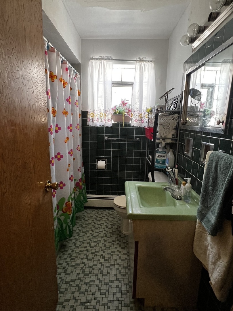 456 North Wolf Road Hillside, IL 60162 - Photo 8 of 16 a bathroom with a sink toilet and shower