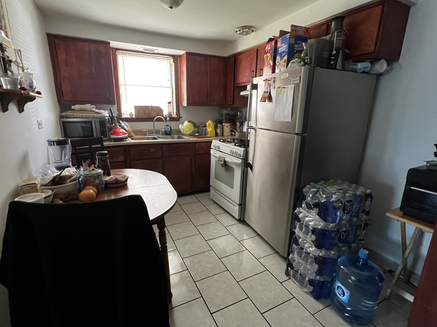 456 North Wolf Road Hillside, IL 60162 - Photo 9 of 16 a kitchen with a refrigerator and a stove top open