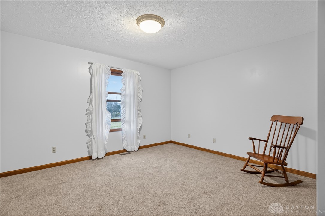 5264 Frazier-Guy Road Sidney, OH 45365 - Photo 30 of 51 This cozy bedroom features plush carpeting and a large window providing abundant natural light.