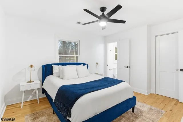 a bedroom with a large bed and a chandelier