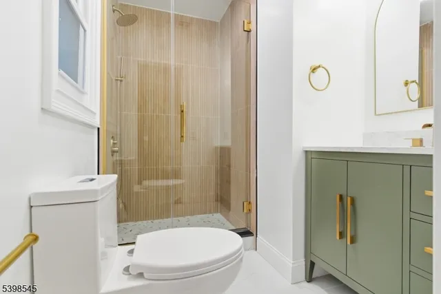 a bathroom with a toilet a sink and shower