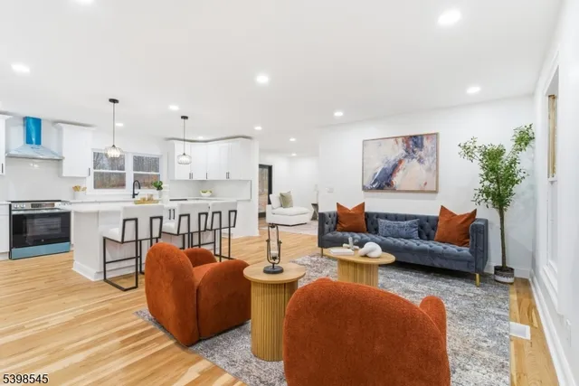 a living room with furniture and kitchen view