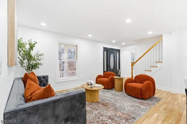 a living room with furniture a rug and a window