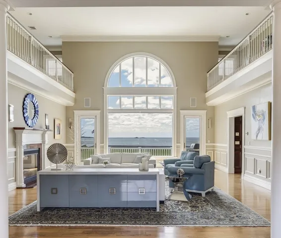 a living room with furniture a fireplace and a large window