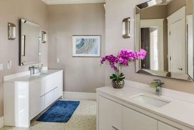 a bedroom with a bed mirror and a window