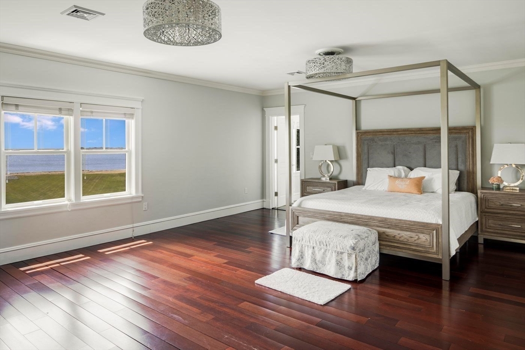 76 Paine Avenue Beverly, MA 01965 - Photo 26 of 41 a bedroom with a bed mirror and a window