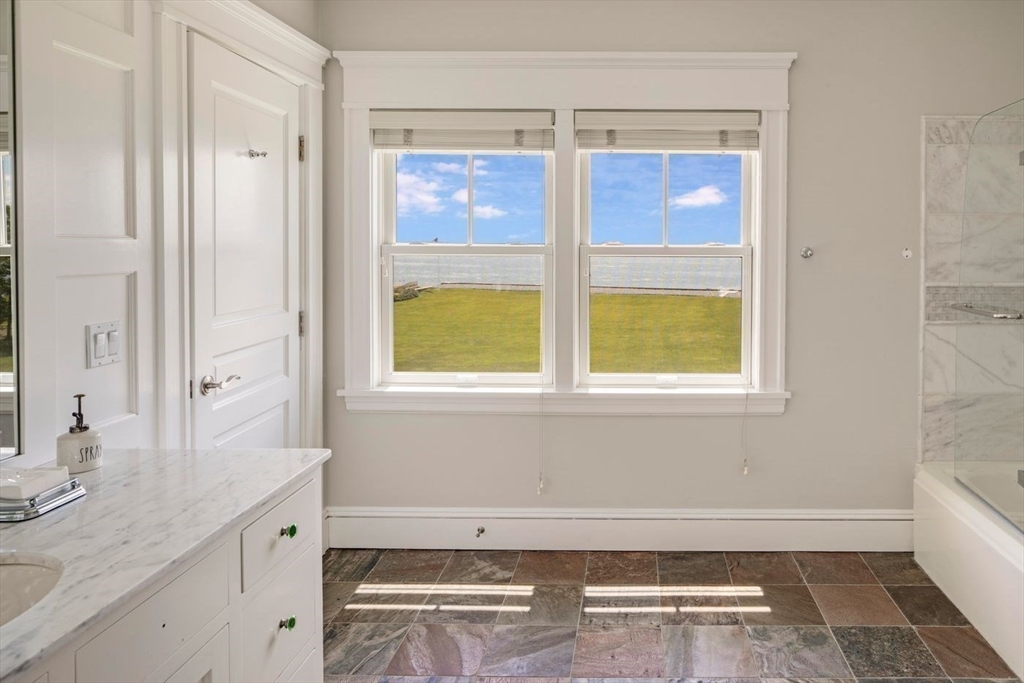 76 Paine Avenue Beverly, MA 01965 - Photo 28 of 41 a bathroom with a granite countertop sink and a bathtub next to a window