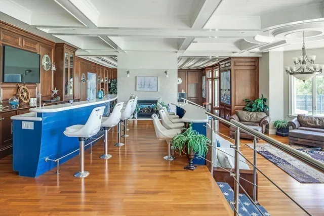 a room with furniture pool table and glass windows