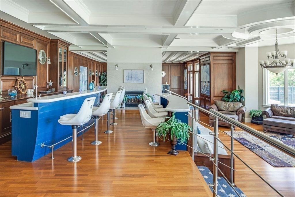 76 Paine Avenue Beverly, MA 01965 - Photo 31 of 41 a dining hall with couches a flat tv screen and potted plant with kitchen view